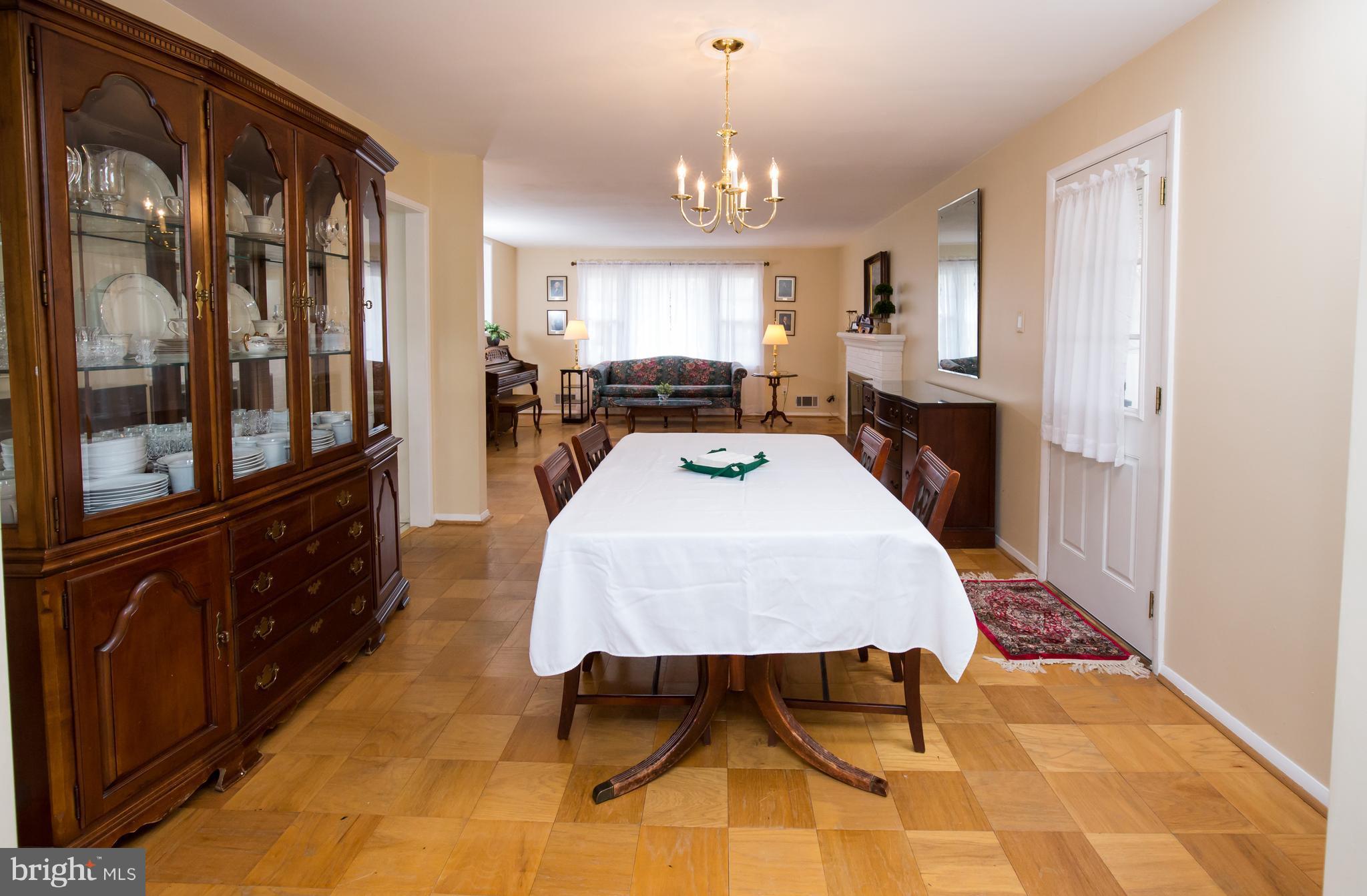 5227 Milland Street Springfield, VA 22151 - Photo 7 of 28 a bed room with a bed and a chandelier