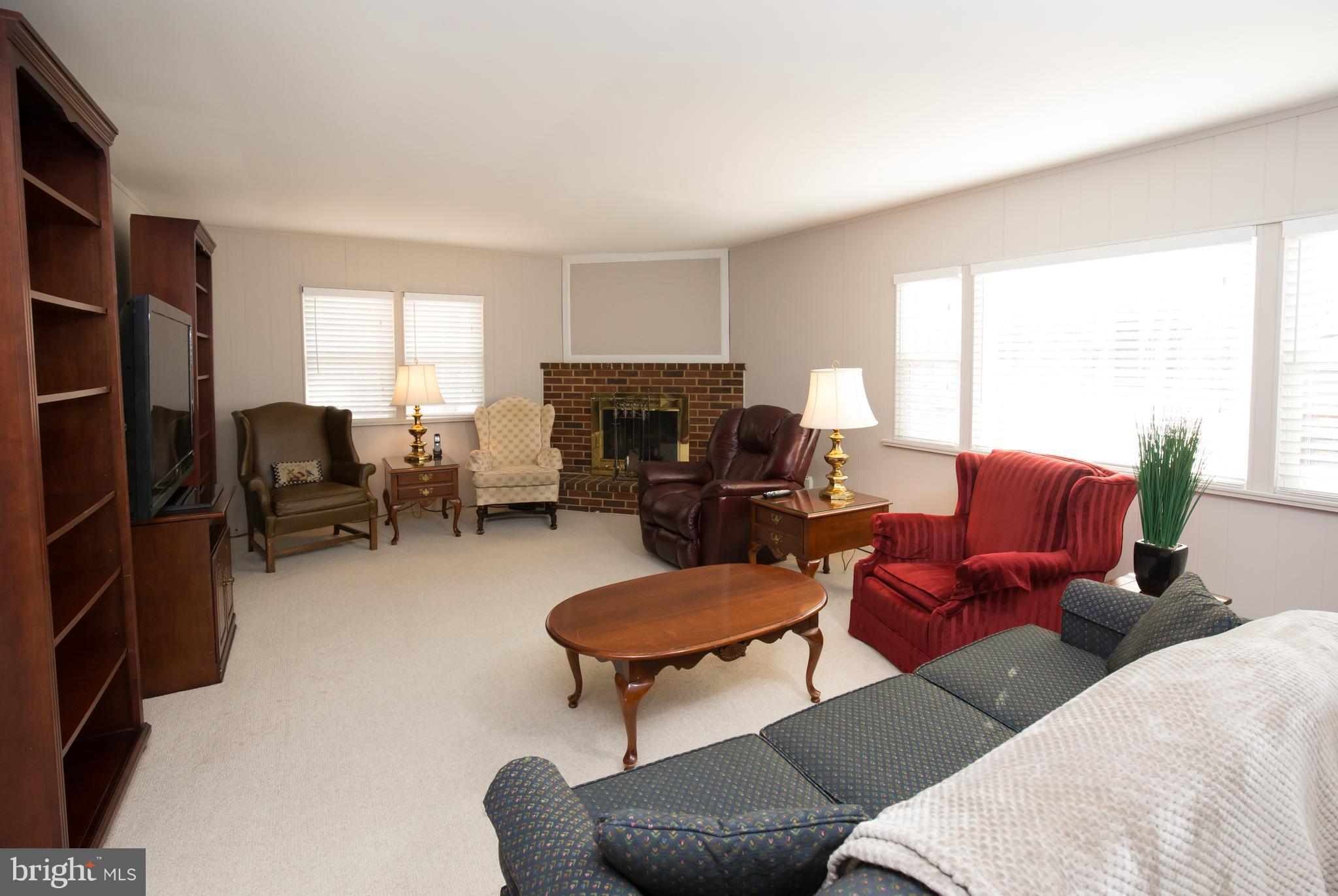 5227 Milland Street Springfield, VA 22151 - Photo 10 of 28 a living room with furniture a fireplace and a large window
