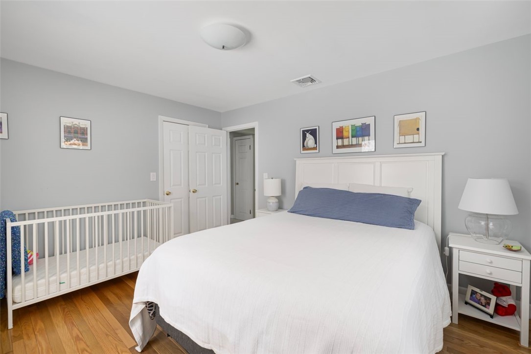117 Moccasin Trail Cranston, RI 02921 - Photo 26 of 43 Bedroom - First floor bedroom, hardwood floors refinished September 2025. Room dimensions 13.1 X 10.8