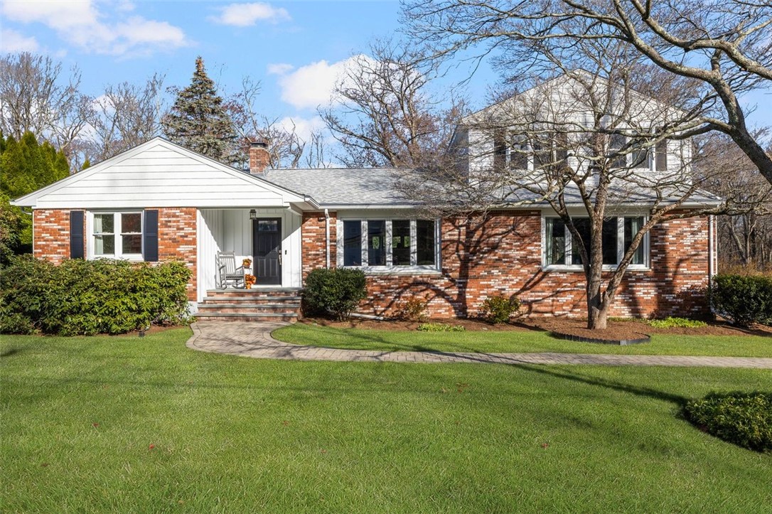 117 Moccasin Trail Cranston, RI 02921 - Photo 40 of 43 Front of Structure - This home features a spacious lot, a brick front exterior, and mature landscaping.
