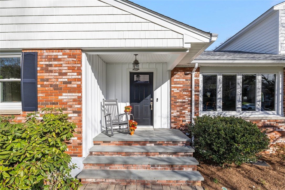 117 Moccasin Trail Cranston, RI 02921 - Photo 41 of 43 Front of Structure - This home features a spacious lot, a brick front exterior, and mature landscaping.