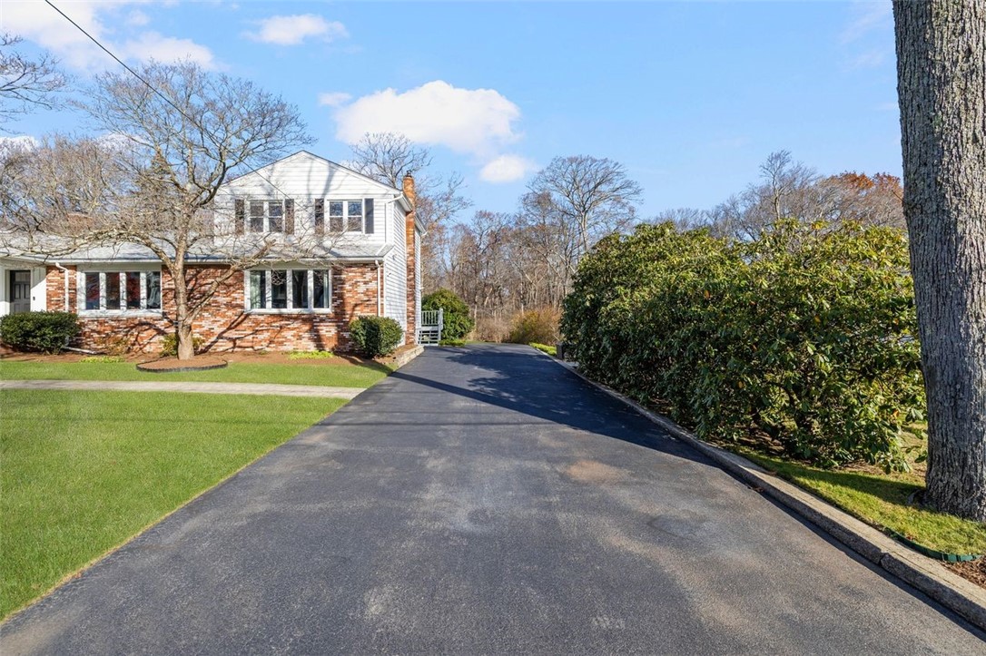 117 Moccasin Trail Cranston, RI 02921 - Photo 42 of 43 Front of Structure - This home features a spacious lot, a brick front exterior, and mature landscaping.