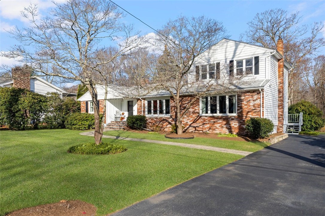 117 Moccasin Trail Cranston, RI 02921 - Photo 43 of 43 Front of Structure - This home features a spacious lot, a brick front exterior, and mature landscaping.
