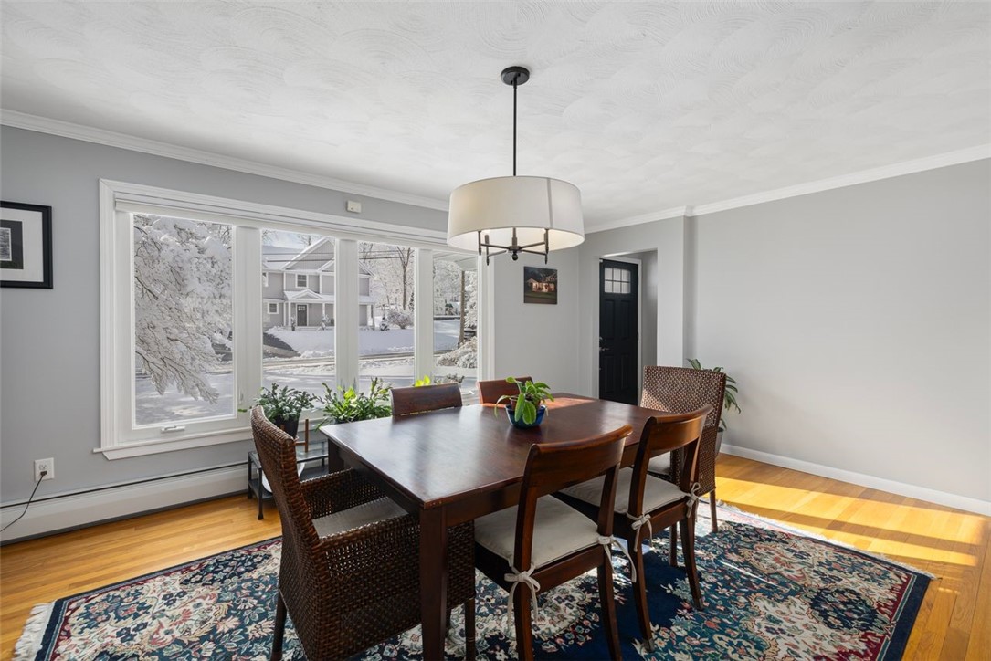 117 Moccasin Trail Cranston, RI 02921 - Photo 7 of 43 Dining Room - This southern facing dining room features plentiful natural light, beautiful hardwood flooring and custom blinds.