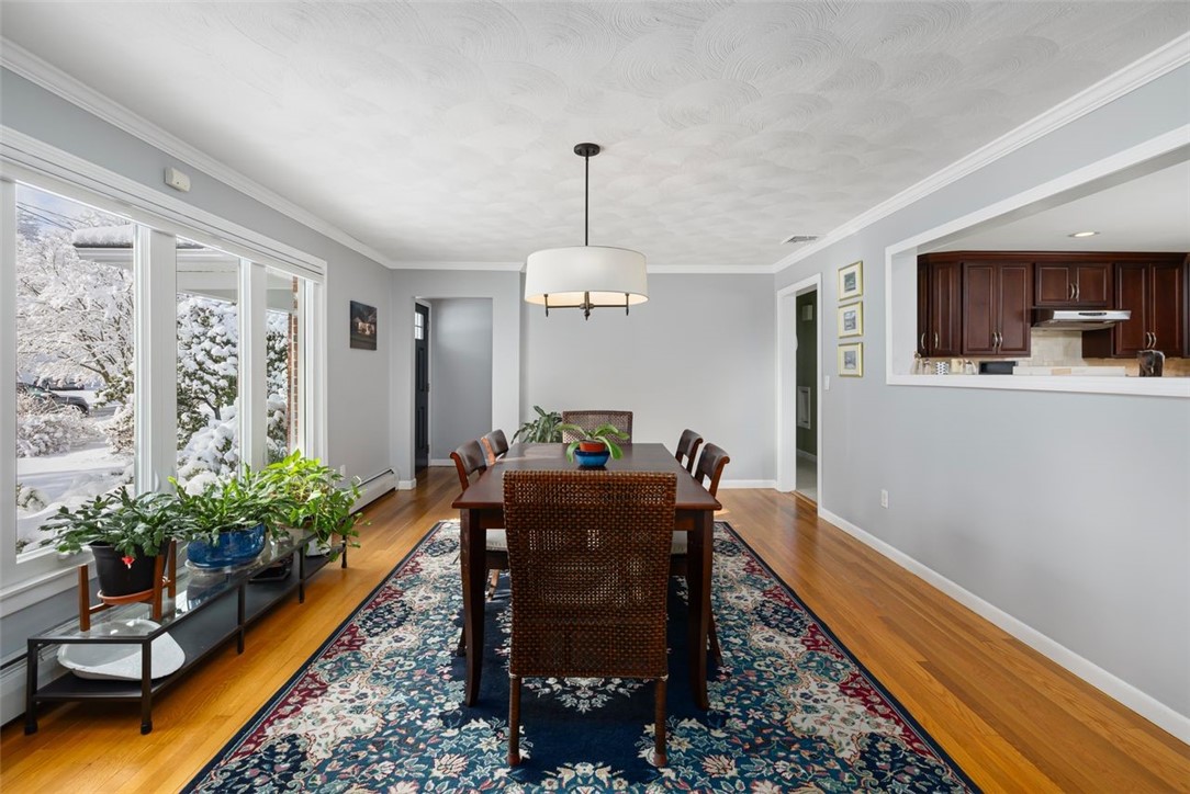 117 Moccasin Trail Cranston, RI 02921 - Photo 8 of 43 Dining Room - This southern facing dining room features plentiful natural light, beautiful hardwood flooring and custom blinds.