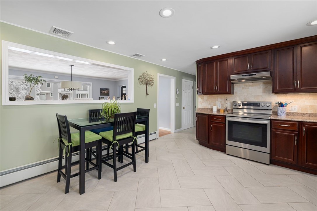 117 Moccasin Trail Cranston, RI 02921 - Photo 9 of 43 Kitchen - This expansive eat in kitchen features plenty of space for your breakfast table, custom tile flooring and access to the dining room.