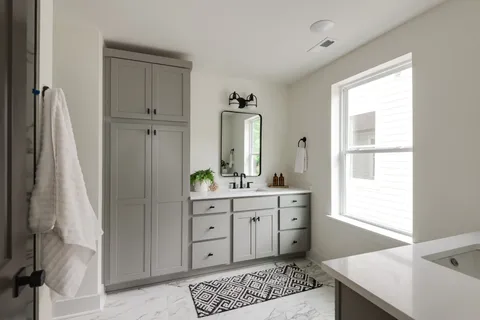 a bathroom with a double vanity sink and mirror