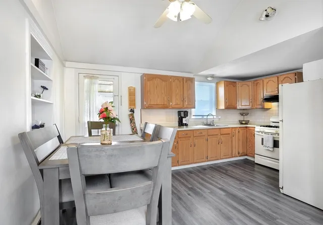 a kitchen with granite countertop white cabinets and stainless steel appliances