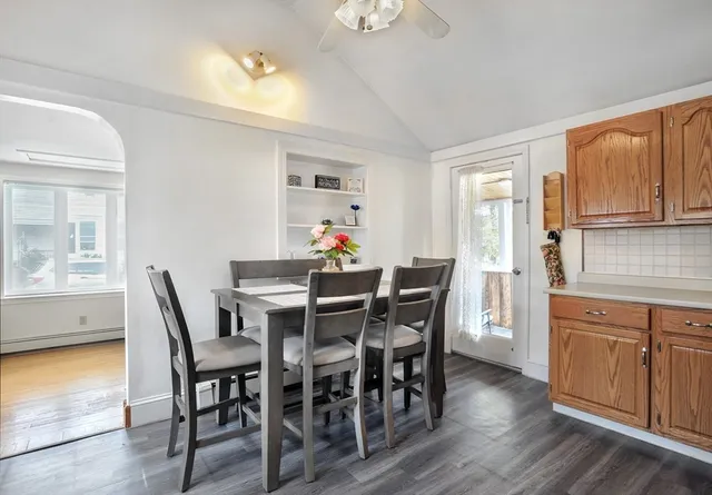 a view of a dining room with furniture and wooden floor