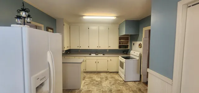a kitchen with a refrigerator sink and stove