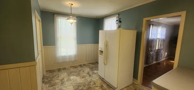a view of a hallway with wooden cabinets