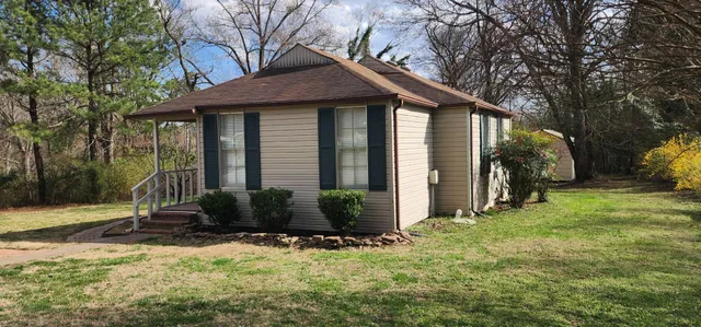 a front view of a house with garden