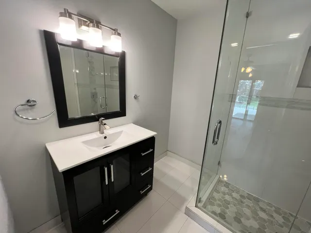 a bathroom with a sink a mirror and vanity
