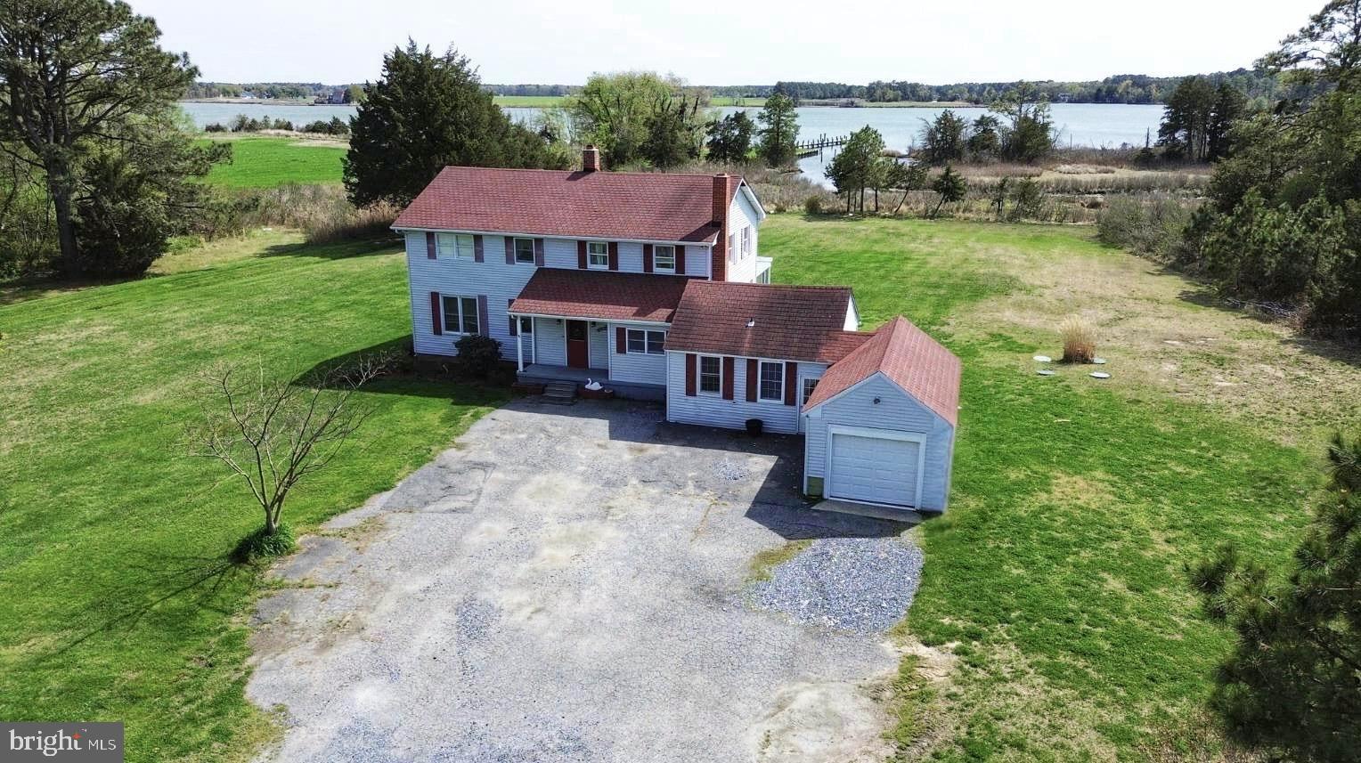 an aerial view of a house with garden space and a street view