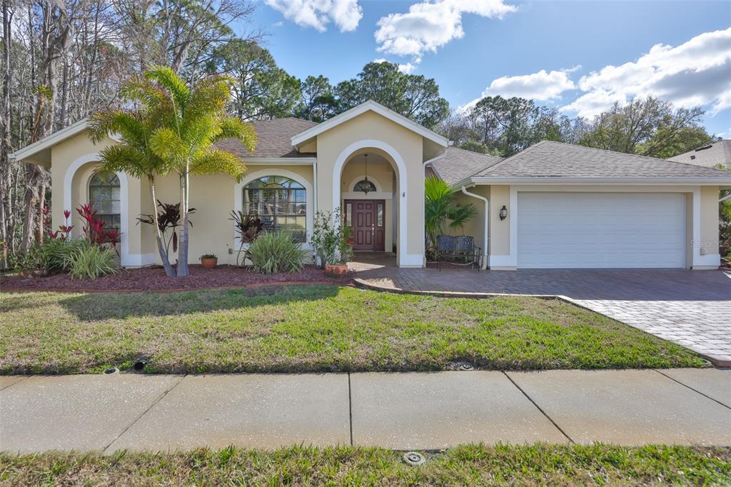 7532 Cheltnam Court New Port Richey, FL 34655 - Photo 1 of 1 a front view of a house with a garden