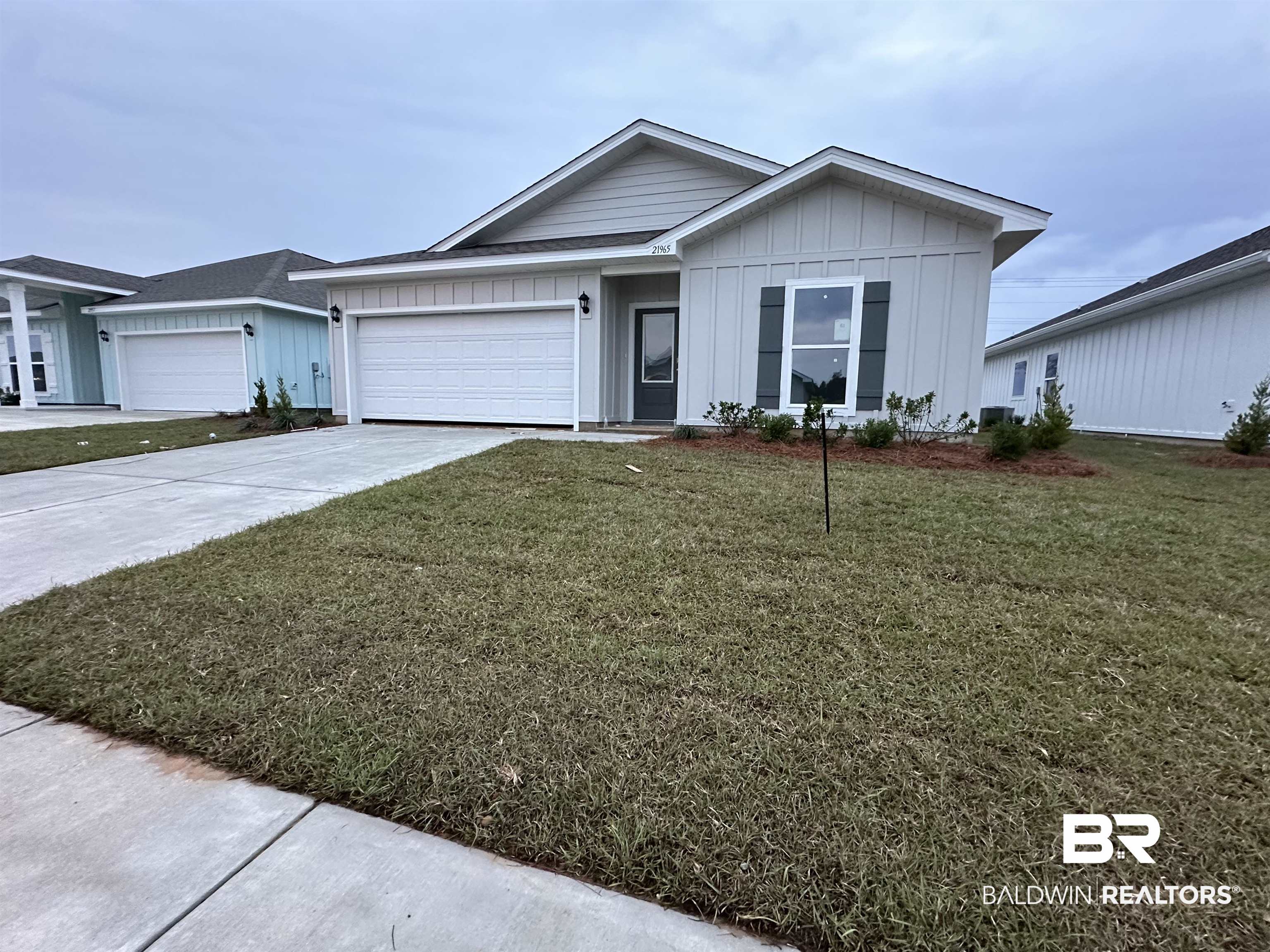 21965 Aleutian Avenue Foley, AL 36535 - Photo 2 of 74 View of front facade featuring a garage and a front lawn