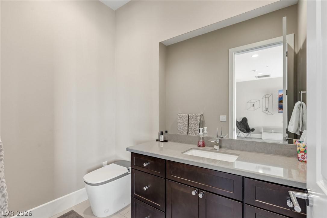 5 Crystal Tree Pass Henderson, NV 89052 - Photo 36 of 67 A chic bathroom offers a modern vanity and sleek toilet for ultimate comfort.