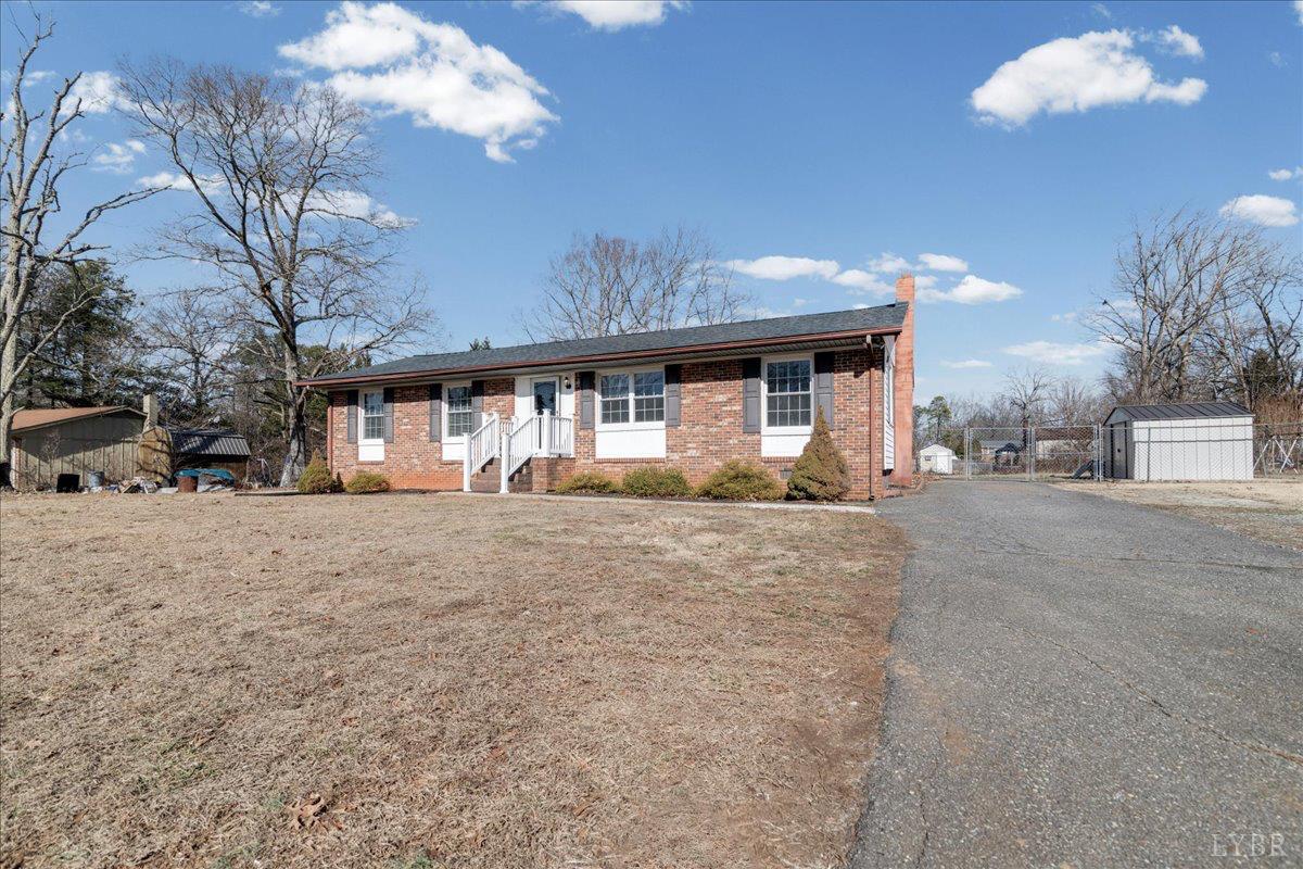 813 Doss Road Concord, VA 24538 - Photo 3 of 31 a front view of a house with a yard and garage