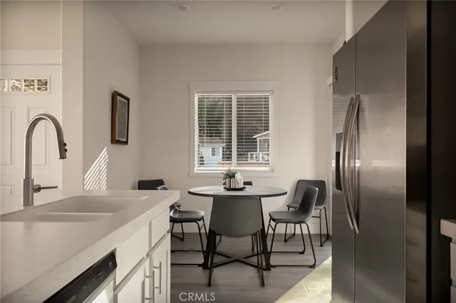 a view of living room filled with furniture and flat screen tv