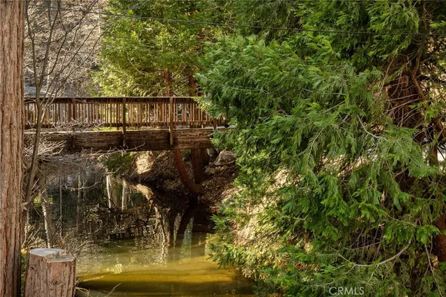 a view of a balcony with wooden floor and fence