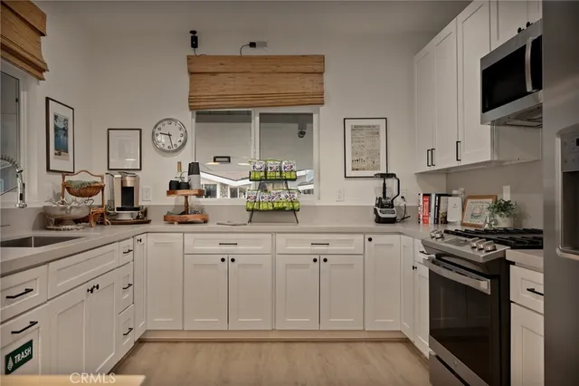 a kitchen with white cabinets and a sink