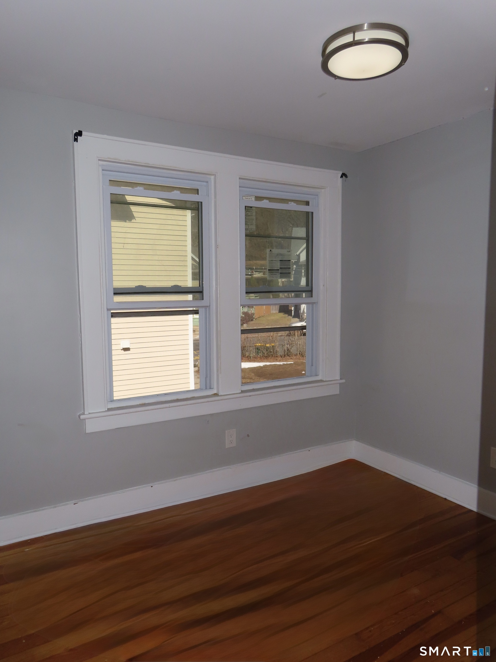40 Winter Street Ansonia, CT 06401 - Photo 12 of 24 an empty room with wooden floor and windows