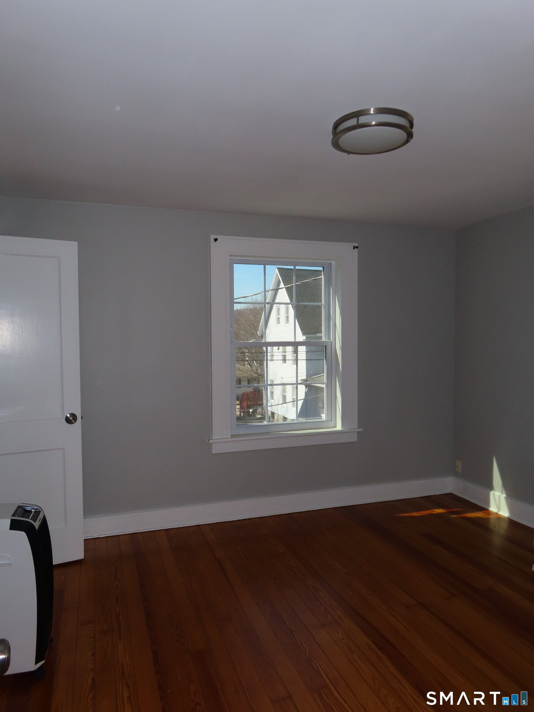 40 Winter Street Ansonia, CT 06401 - Photo 13 of 24 an empty room with wooden floor and windows