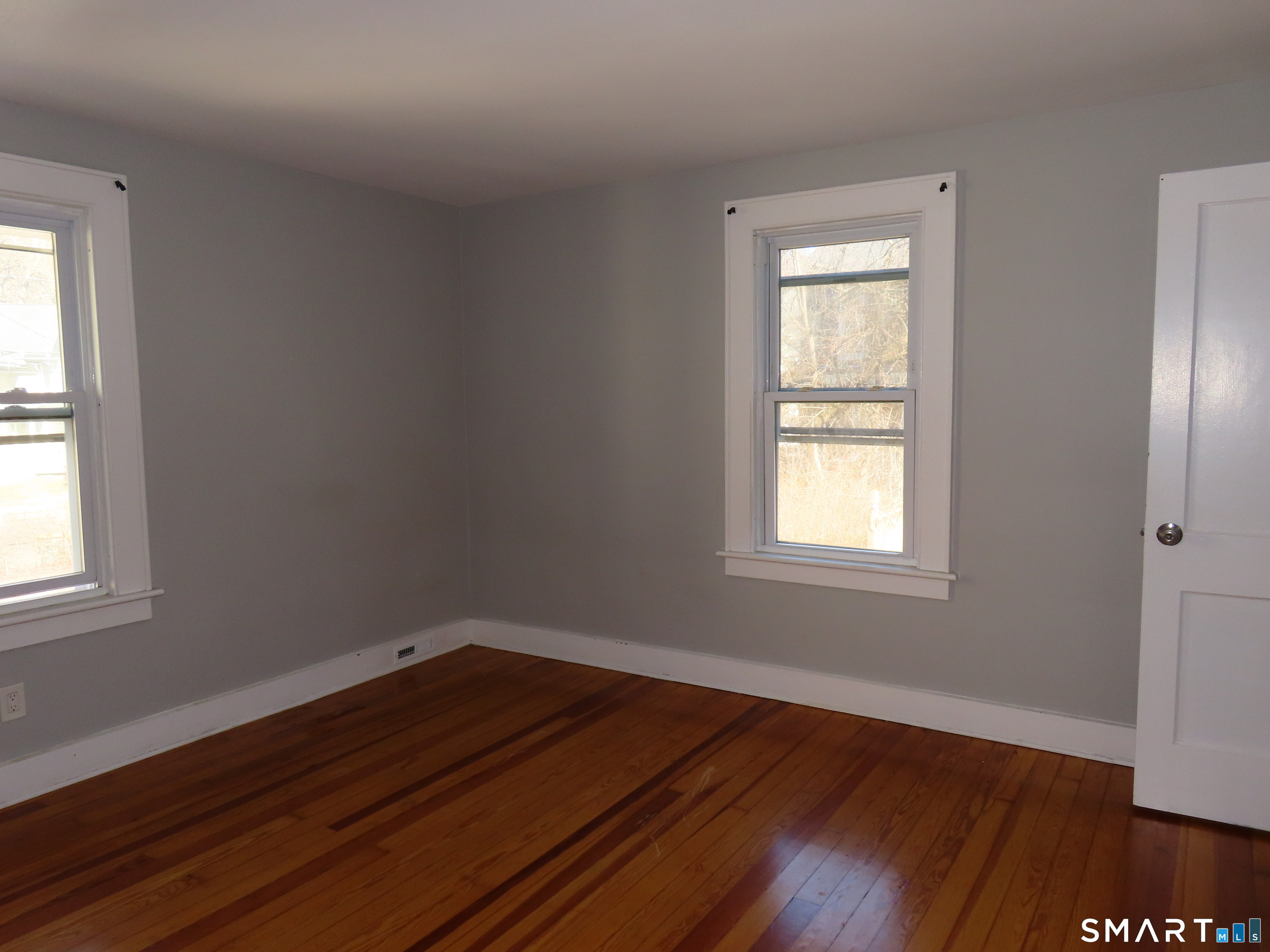40 Winter Street Ansonia, CT 06401 - Photo 15 of 24 an empty room with wooden floor and windows
