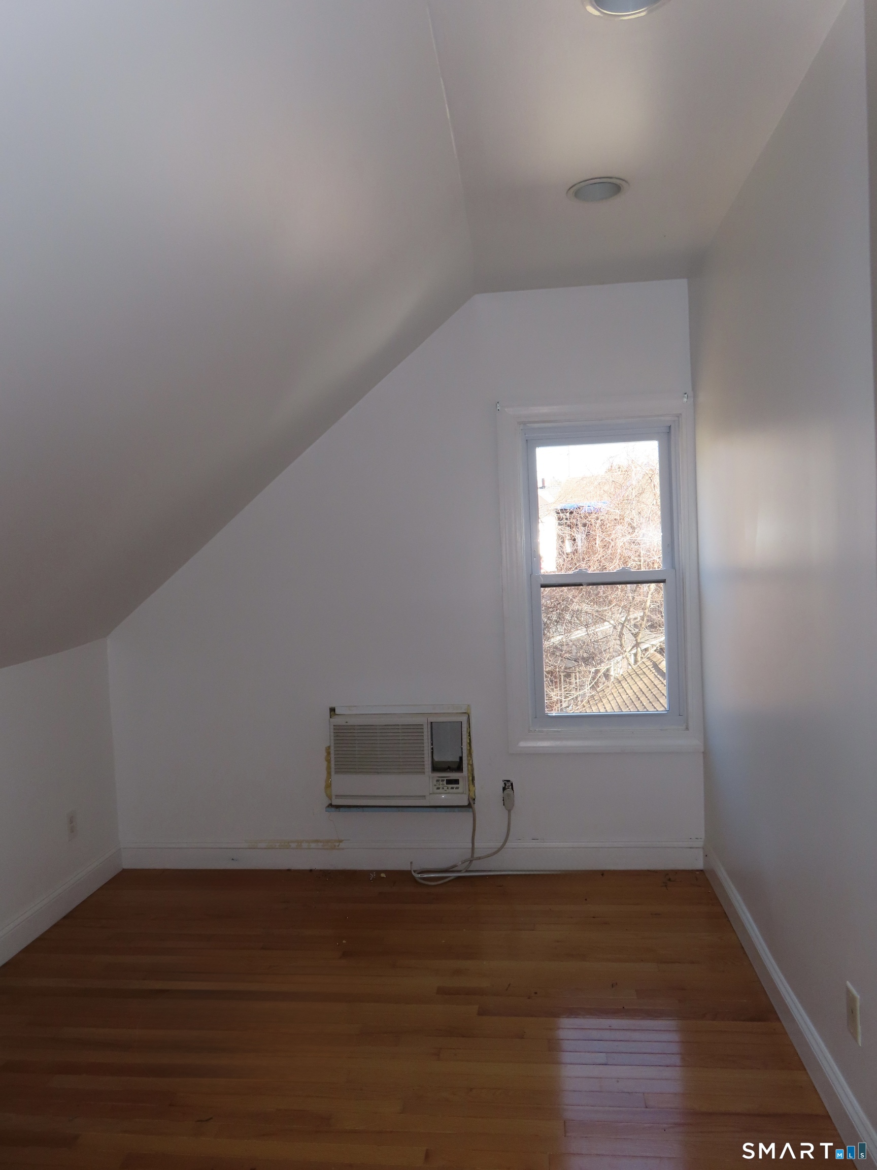 40 Winter Street Ansonia, CT 06401 - Photo 18 of 24 a view of an empty room with wooden floor and a window