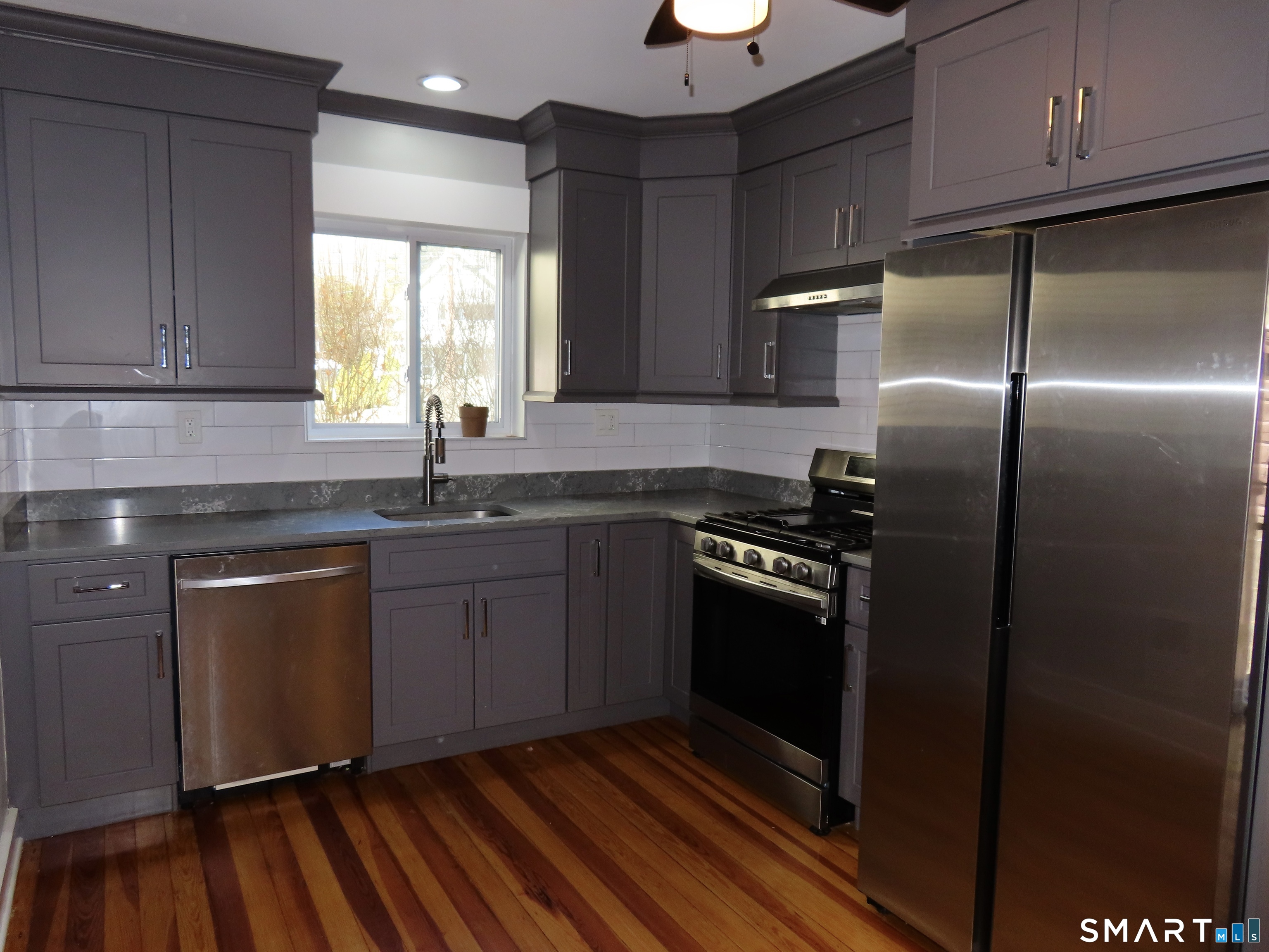 40 Winter Street Ansonia, CT 06401 - Photo 2 of 24 a kitchen with granite countertop stainless steel appliances a sink cabinets and a counter top space