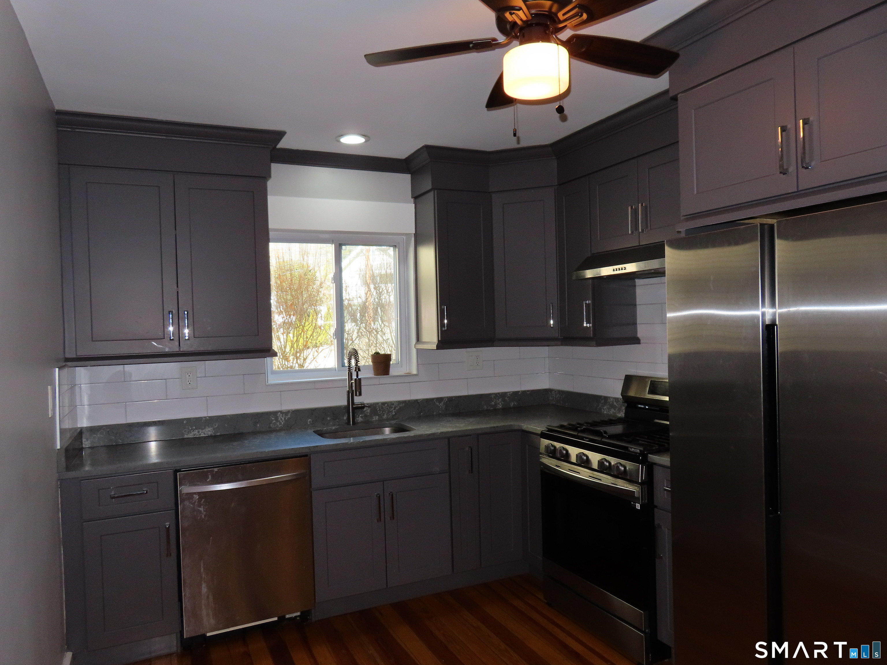 40 Winter Street Ansonia, CT 06401 - Photo 3 of 24 a kitchen with stainless steel appliances granite countertop a sink a stove cabinets and a refrigerator