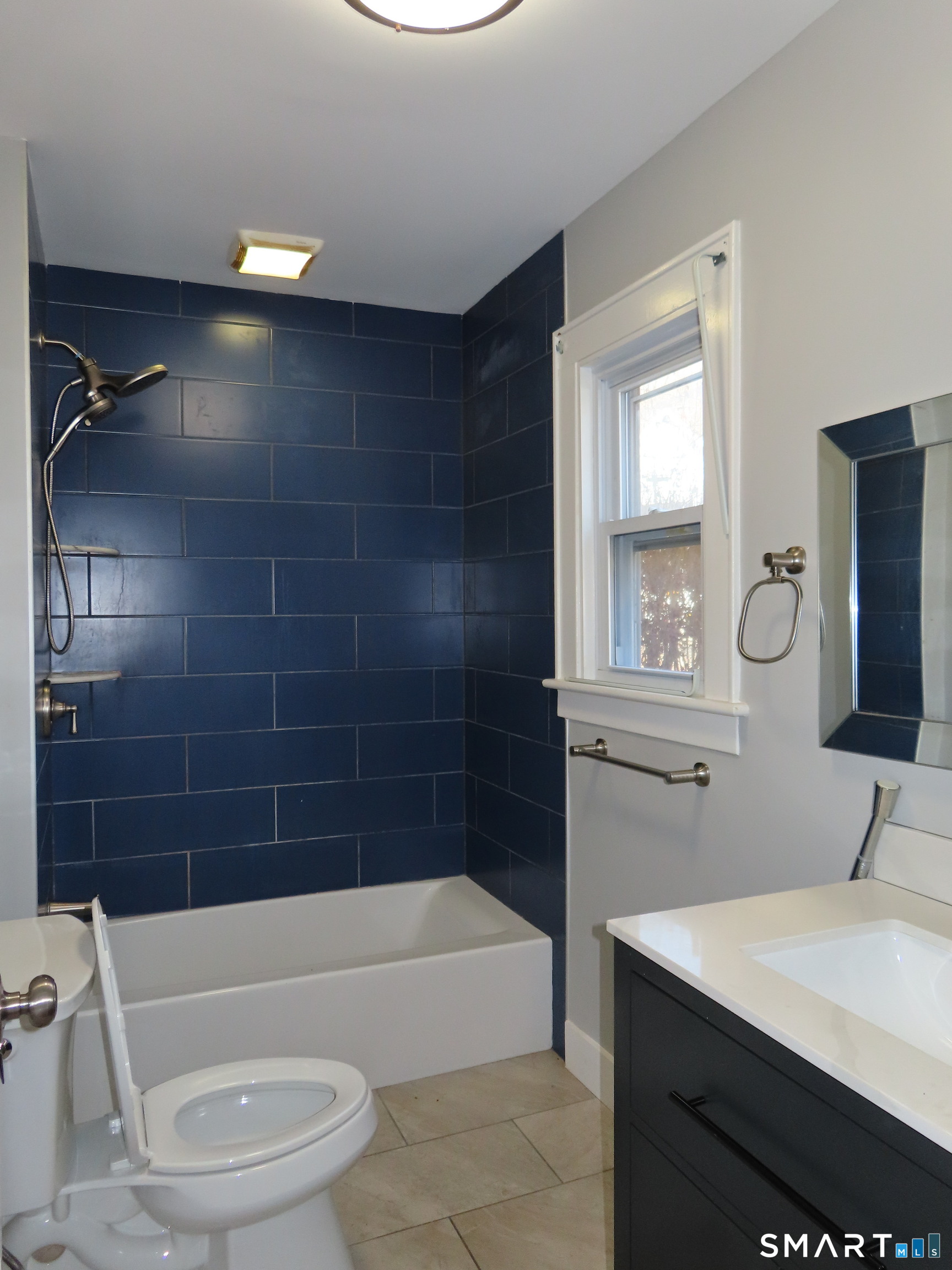 40 Winter Street Ansonia, CT 06401 - Photo 4 of 24 a bathroom with a bathtub a sink a toilet and a mirror