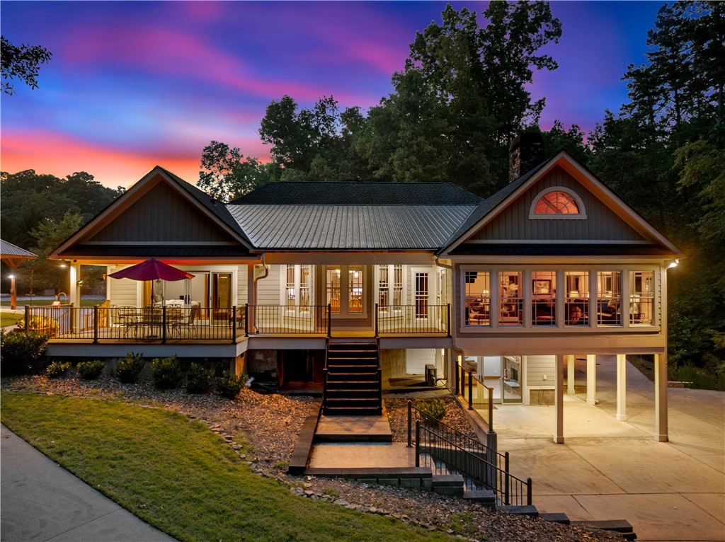 285 Bertha Allen Road Westminster, SC 29693 - Photo 1 of 50 Twilight glows over a welcoming hillside residence with generous decking and a spacious drive.