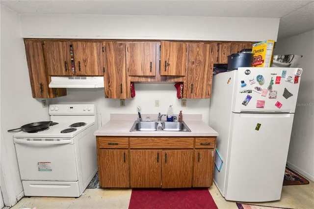 a room with wooden cabinets washer and dryer