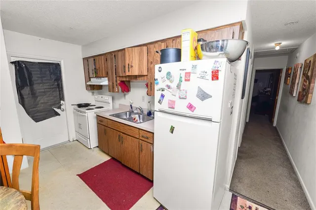 a kitchen with a refrigerator and a sink