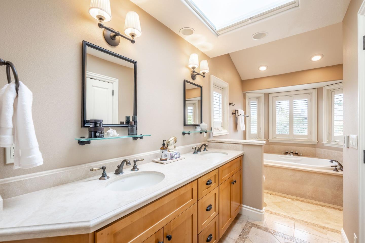 2107 Winged Foot Road Half Moon Bay, CA 94019 - Photo 14 of 29 a bathroom with double vanity sinks double vanity tub shower and a mirror
