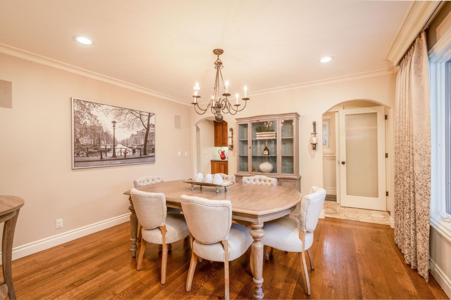 2107 Winged Foot Road Half Moon Bay, CA 94019 - Photo 9 of 29 a dining room with wooden floor a chandelier a wooden table and chairs