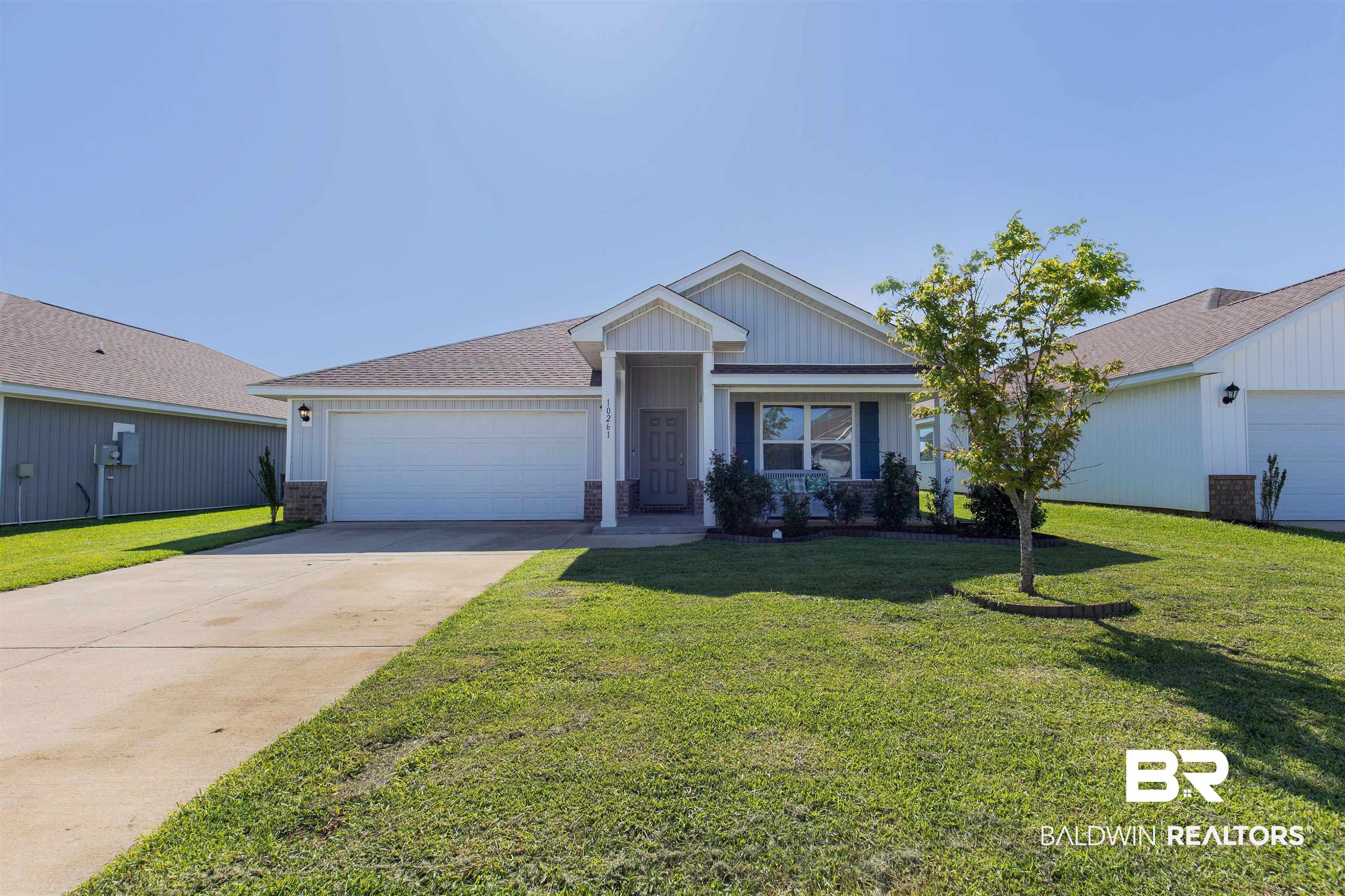 10261 Ruffian Route Daphne, AL 36526 - Photo 1 of 28 View of front facade featuring an attached garage, concrete driveway, and a front lawn