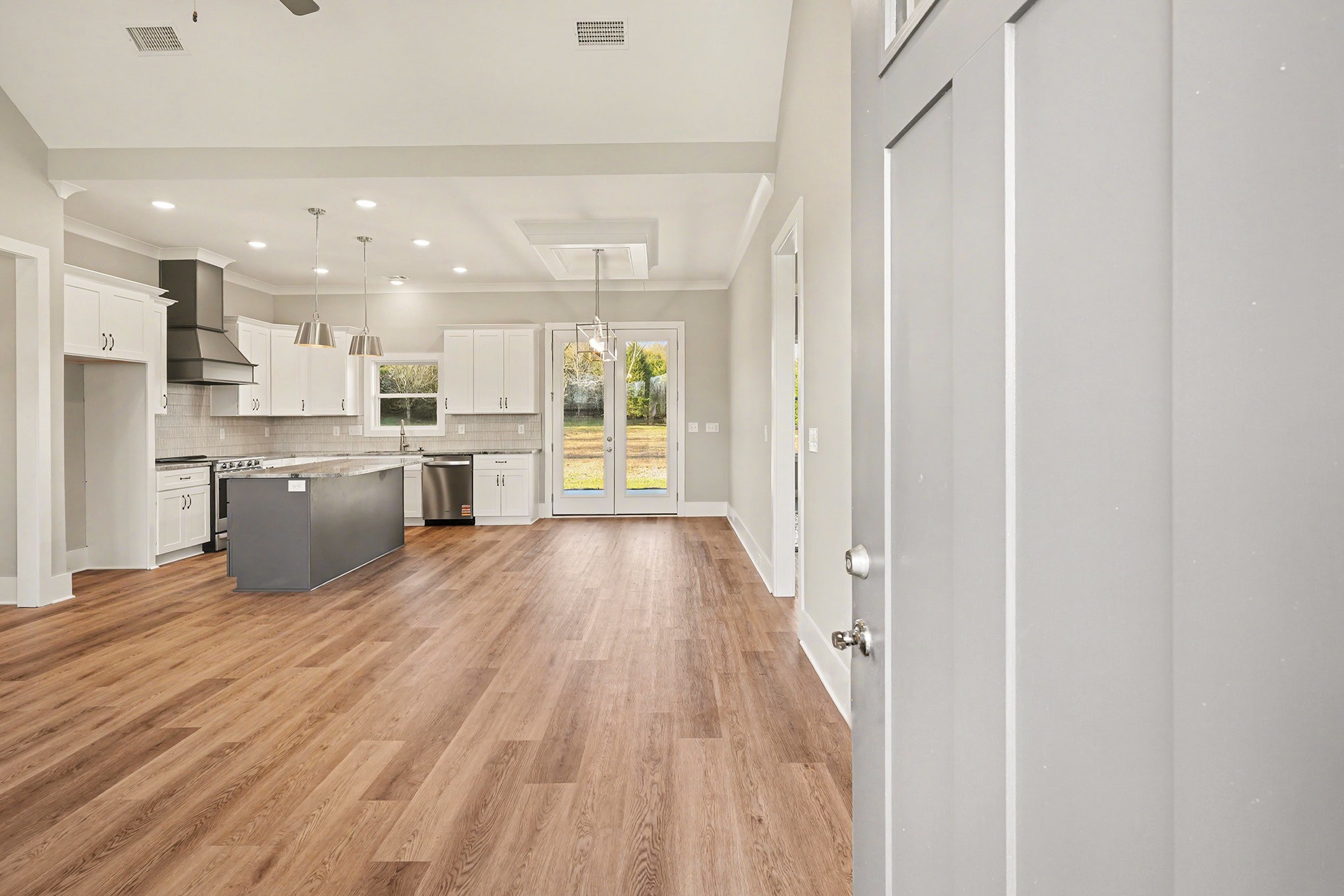 412 Harsh Lane Castalian Springs, TN 37031 - Photo 12 of 36 a view of a kitchen with wooden floor and a window