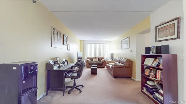 a living room with furniture and a book shelf