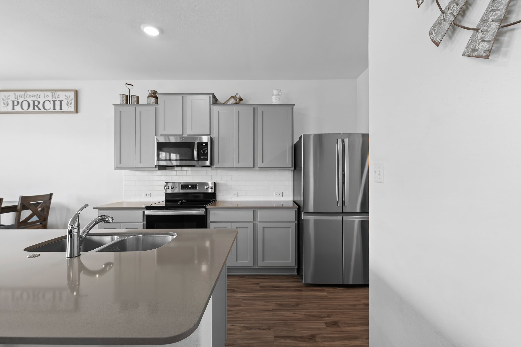 576 Greatest Gift Way Jarrell, TX 76537 - Photo 10 of 37 Culinary adventures await in this kitchen featuring abundant cabinetry and a modern appliance suite.