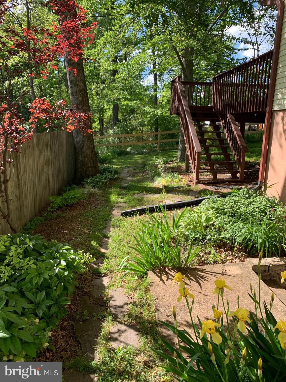 2408 Old Frederick Road Catonsville, MD 21228 - Photo 51 of 53 a view of a backyard with plants and a bench