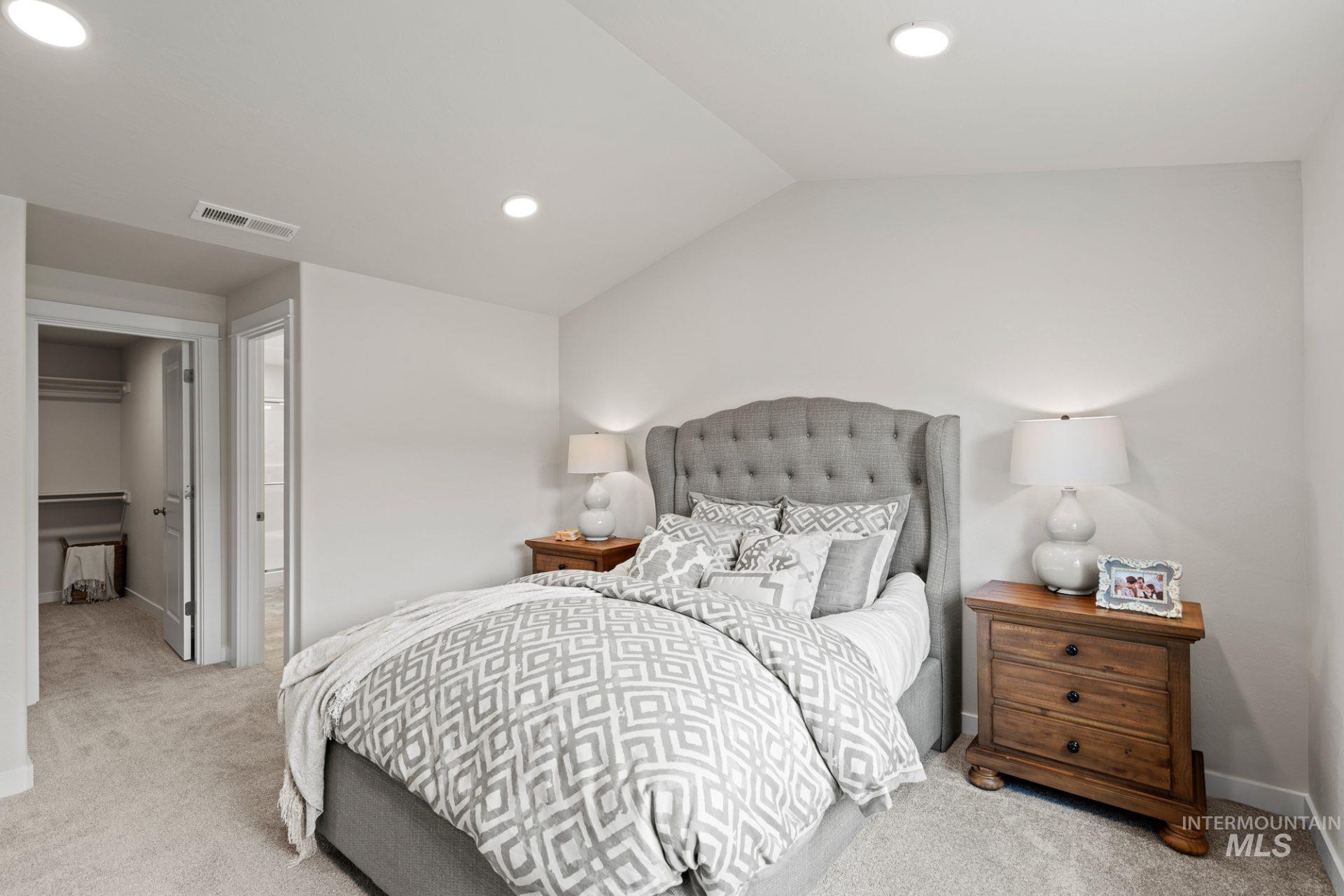 868 Adamite Road Kimberly, ID 83341 - Photo 11 of 22 Bedroom with carpet floors, recessed lighting, a walk in closet, and lofted ceiling