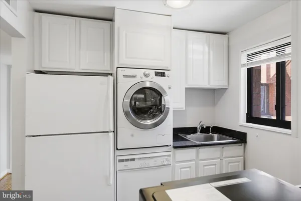 a kitchen with stainless steel appliances granite countertop a sink a refrigerator and a stove