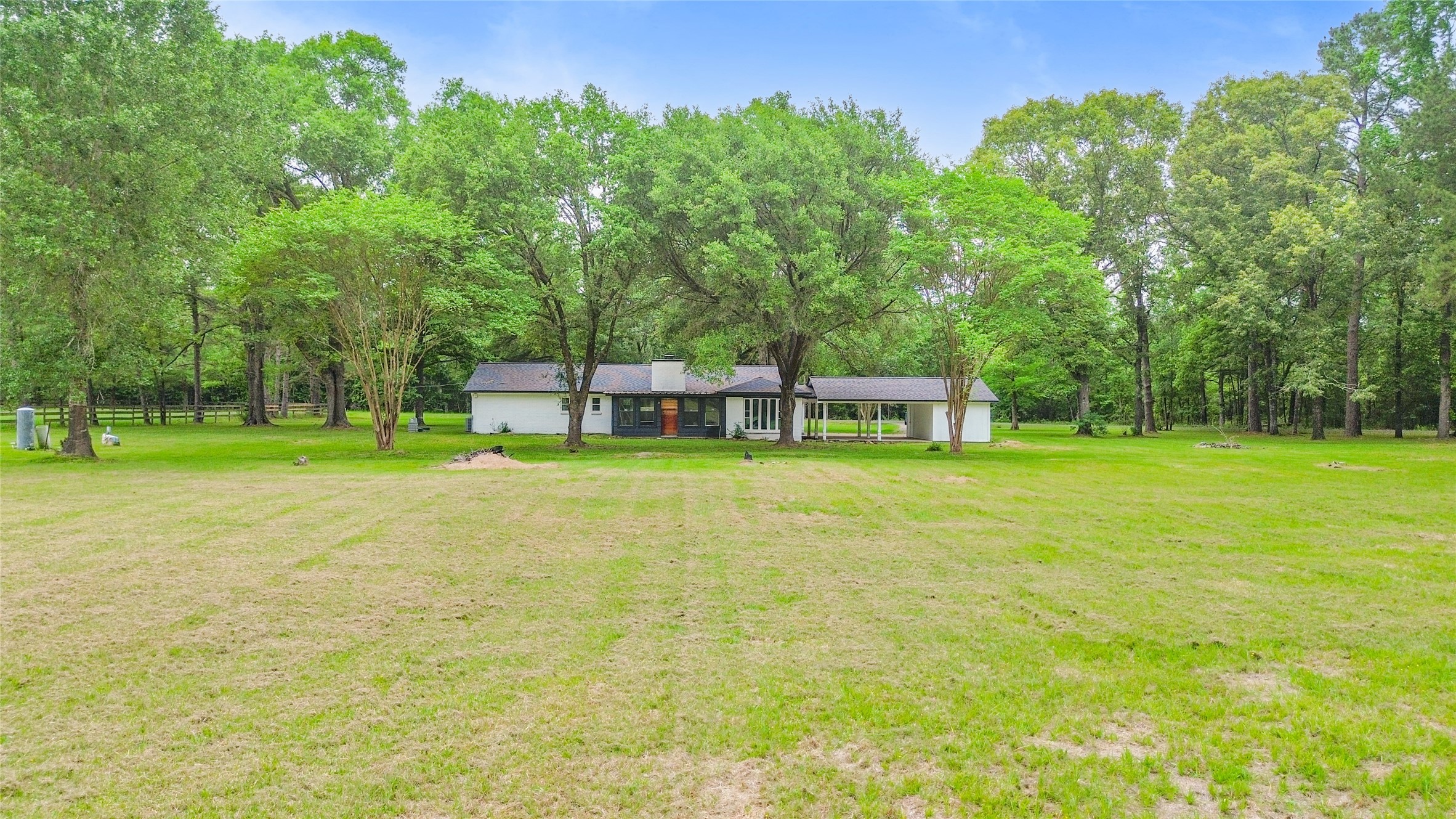 74 Robinson Road Huntsville, TX 77320 - Photo 26 of 33 a view of a house with a backyard and a tree