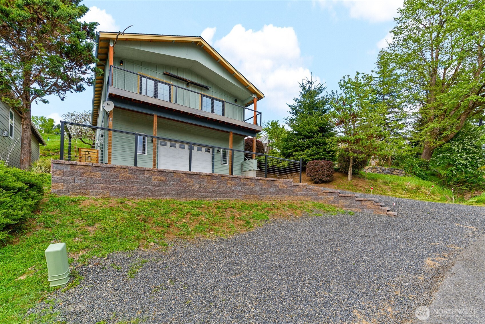 461 Northwest Jefferson Street Stevenson, WA 98648 - Photo 1 of 38 a front view of a house with a yard and garage
