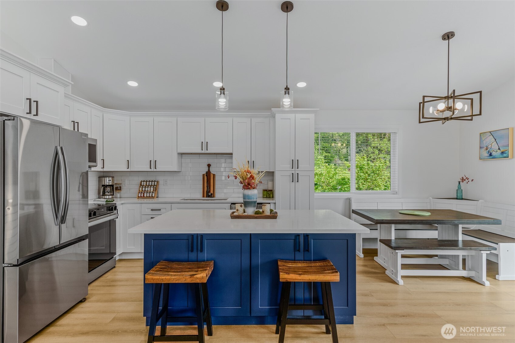 461 Northwest Jefferson Street Stevenson, WA 98648 - Photo 11 of 38 a kitchen with stainless steel appliances granite countertop a stove a refrigerator and a dining table with wooden floor