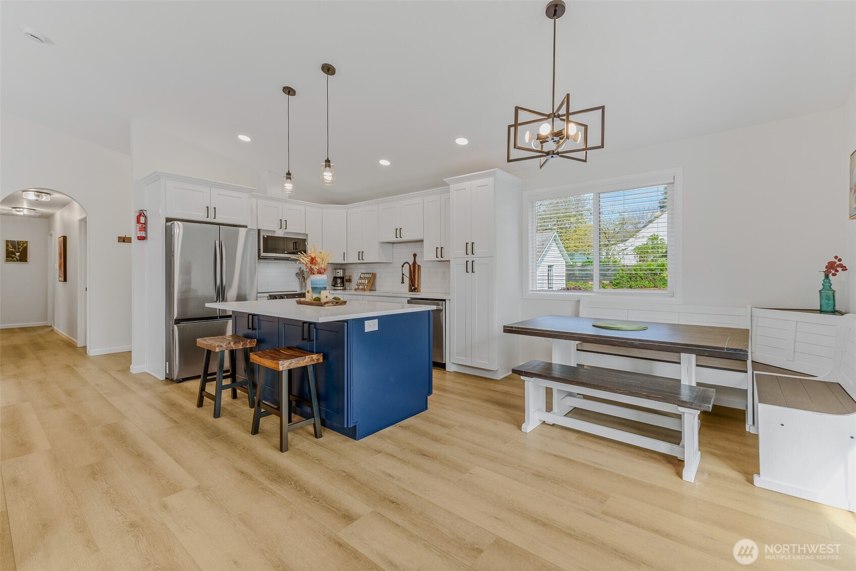 461 Northwest Jefferson Street Stevenson, WA 98648 - Photo 12 of 38 a view of a dining room with furniture a chandelier and wooden floor