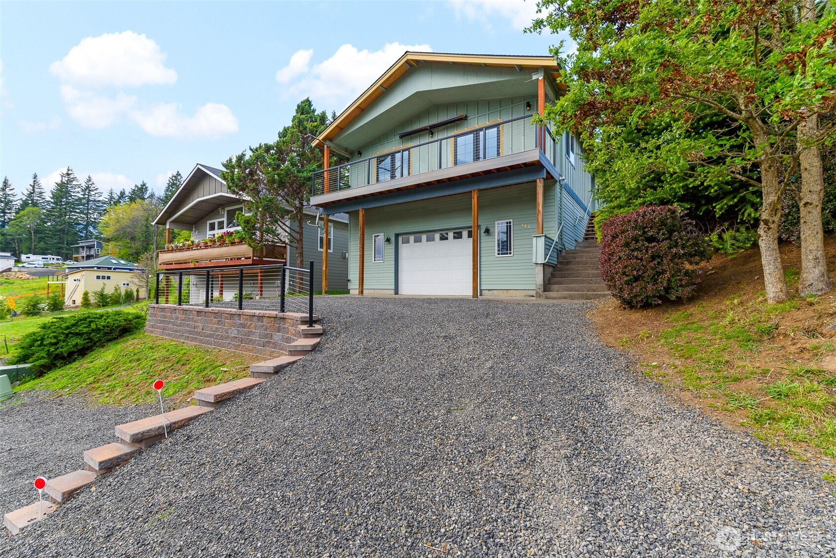 461 Northwest Jefferson Street Stevenson, WA 98648 - Photo 3 of 38 a front view of a house with a garden and trees