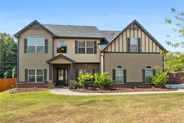 a front view of a house with a yard and garage